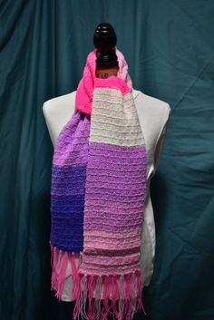 a purple, pink and white scarf on top of a mannequin