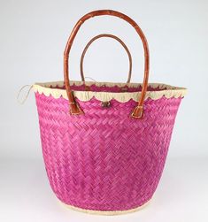 These beautiful pieces are designed in South Africa. Handmade with raffia and featuring leather handles, these bags bring the perfect mix of bohemian chic to everyday wear! Capable of being used as a handbag, basket or storage-this multi-purpose piece is a cannot miss! The double closure top provides a multi-style capability as well! Sizing: 16 inches wide x 12 inches deep x 13 inches high Bohemian Straw Bag With Bamboo Handle For Shopping, Bohemian Shoulder Bag With Bamboo Handle For Shopping, Beach Bag With Bamboo Handles For Shopping, Beach Bag With Bamboo Double Handles For Shopping, Bohemian Bucket Bag With Bamboo Handle, Bohemian Basket Bucket Bag For Beach Season, Bohemian Crochet Bucket Bag With Leather Handles, Summer Straw Bag With Round Handle For Shopping, Pink Straw Bag With Braided Handles For Beach