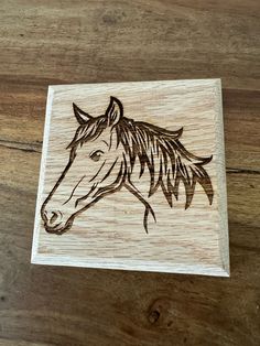 a wooden stamp with a horse's head on it