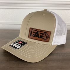 F Around and Find Out! Make a bold statement with our eye catching FAFO side patch hat. Specifications: 🧢 Richardson original 112 trucker; adjustable for the perfect fit 🎩 60/40 cotton/polyester blend for comfort 📏 One size fits most 🏷️ Expertly laser engraved leatherette patch design 📦 Ships in 2 to 3 business days from our Orlando Studio Care Instructions: 🚫 Do not wash; spot clean only Please Note: 🌈 Colors may vary from photos based on your viewing screen. White Snapback Trucker Hat With Leather Patch, White Snapback Hat With Leather Patch, White Trucker Hat With Leather Patch, Adjustable White Trucker Hat With Leather Patch, Adjustable White Hat With Patches, Adjustable White Baseball Cap With Patches, Adjustable White Patched Baseball Cap, White Hat With Logo Patch For Outdoor, White Outdoor Hat With Logo Patch