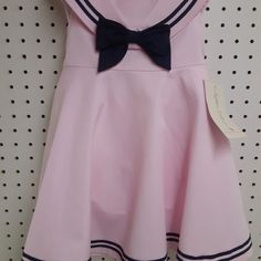 Cute Brand New With Tag Sophia Rose Sleeveless Pink Sailor Collar Dress. In Pink And Navy Blue....Has Separate Panties To Go Along With It. Zippered Back And Ties..........Size 18 Mos Measures: 8" Shoulder To Shoulder (Not Collar) .......9.5" Underarm To Underarm.......19" Shoulder To Bottom Of Dress. Has Nice Square Collar, Big Navy Bow, And Navy Stripe Trim Around Collar And Bottom Of Dress. Made Of 60% Cotton And 40% Polyester. Fitted Pink Dress For School, Preppy Pink School Dress, Preppy Pink Dress For Spring, Pink Preppy Cotton Dress, Cute Pink School Dress, Preppy Pink Spring Dress, Pink Cotton School Dress, Pink Cotton Dress For School, Preppy Pink Sleeveless Dress