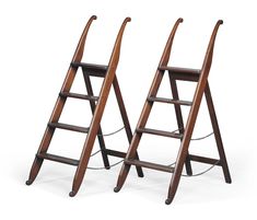 two wooden ladders are standing next to each other