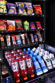 a vending machine filled with lots of different types of juices and condiments