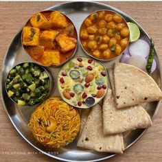 a metal plate topped with different types of food