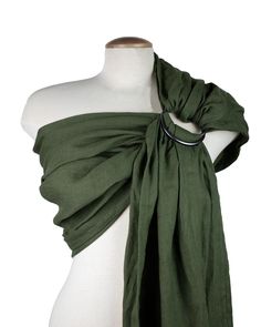 a mannequin wearing a green scarf on top of a white dress form with a black metal ring around the neck