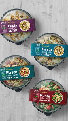 three bowls of pasta with different toppings on them