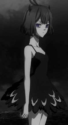 a girl in a black dress standing on the beach with her arms behind her back