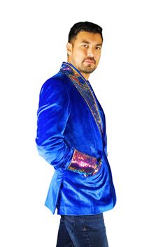 This mens royal blue velvet smoking jacket exudes a certain sophistication that other jackets can only dream of. We have taken this perfectly tailored,double breasted blazer to the next level with the addition of iridescent multi color flip sequins. FEATURES: Double breasted Fully lined with our signature satin 4 pockets including 1 inside breast pocket Reversible iridescent sequin contrast collar, cuffs and trim Velvet trimmed collar to for ultimate comfort Ethically made in-house in our studio Royal Blue Party Blazer, Winter Party Blue Blazer, Blue Velvet Winter Outerwear, Blue Fitted Blazer For Night Out, Fitted Blue Blazer For Night Out, Royal Fitted Blazer For Party, Fall Party Blazer With Shawl Collar, Blue Single Breasted Blazer For Party, Party Blue Single Breasted Blazer