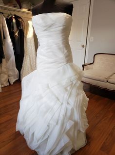 a white wedding dress on display in a store