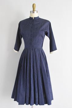 "Vintage 1950s medium weight cotton daydress. Navy blue with double white vertical pin stripes. High collar with a white ruffled backing, longer sleeves, and seamed bodice. Nipped waist. Front button and side metal zipper closure. State of garment | very good, tinge yellowing to the white ruffle detailing. request further photos if needed. Measurements ✂--- best fit | Extra Small bust | up to 36\" shoulders | not specified shoulder to waist | 15.5\" sleeves | not specified waist |24 \" hips | fr Classic Striped Cotton Dress, Fitted Cotton Dress With Pintucks, Vintage Cotton Pleated Dress, Vintage Pleated Cotton Dress, Sewing Blocks, Waterfall Skirt, 1950s Fashion, Metal Zipper, Small Bust