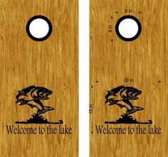 two cornhole game boards with the words welcome to the lake and a fish on it