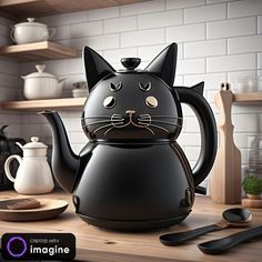 a black cat teapot sitting on top of a wooden table next to utensils