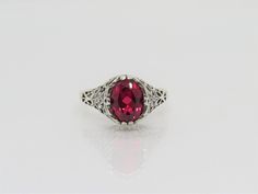 Vintage Sterling Silver Oval cut Ruby Filigree Ring...Marked 925...Total of weights 2.8grams.. Size 9...Measure of Face 10.9mm...It's in very good condition Classic Oval Engraved Ring With Filigree, Classic Oval Ruby Ring With Filigree, Heirloom Oval Ruby Ring With Filigree, Ornate Oval Ruby Ring With Filigree, Classic Oval Sterling Silver Filigree Ring, Classic Oval Filigree Ring Stamped 925, Ornate Oval Filigree Ring Stamped 925, Oval Silver Ruby Filigree Ring, Heirloom Oval Filigree Ring Stamped 925