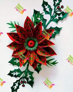 an origami christmas decoration with holly leaves