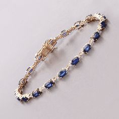 14k Gold Sapphire Bracelet, Genuine Blue Sapphire Ovals and Diamond Gold Bracelet for Women, Real Blue Sapphire and Diamond Tennis Bracelet Crafted in 14K yellow gold, this tennis bracelet showcases 4.18 carats of genuine oval blue sapphires and 0.25 carats of genuine round white diamonds. Celebrate September's birthstone with this elegant and timeless piece, perfect for adding a touch of luxury to any ensemble. Product Details:  14K Yellow Gold Item Type: Bracelet Gross Wt: 8.64 Gemstone Wt: 4. Blue Oval Bracelet For Anniversary, Blue Oval Bracelets For Anniversary, Luxury Dainty Sapphire Jewelry, Elegant Blue Gold Bracelet For Formal Occasions, Blue Gold Bracelet With 17 Jewels For Formal Occasions, Blue Oval Diamond Bracelet For Anniversary, Formal Blue Oval Diamond Bracelet, Blue Jubilee Gold Bracelet In Fine Jewelry Style, Blue Oval Jubilee Bracelet