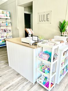 the front desk of a store with lots of items on it