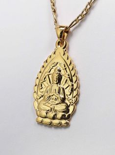 Beautiful Avalokiteshavara Kuan Yin Goddess Gold plated Pendant Necklace  ☆ Kuan Yin has been revered as the       Goddess of Compassion. ☆ She is one of the few feminine deities. ☆ Many women adore her and       feel empowered by her. ☆ Finely detailed Buddha charm     measures 35 mm tall by 20 mm wide     by 1 mm thick.    ☆ Includes a quality 2mm wide       Gold Plated Stainless steel       FIGARO chain       60 cm = 23.6 inches long       with lobster clasp making      this a beautiful pendant necklace. ☆ Eco-packaged in gift box and     reusable decorative gift bag. ☆ FREE USA SHIPPING!      Ships same day as ordered to USA only. ☆ Love and Compassionate      Peace to you & yours ! Spiritual Gold Necklace For Celebration, Spiritual Gold Necklace Gift, Spiritual Gold Jewelry For Gifts, Gold Spiritual Necklace For Gifts, Kuan Yin Goddess, Goddess Birthday, Goddess Of Compassion, Buddha Pendant Necklace, Beautiful Pendant Necklace