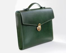 Mens leather briefcase in a classic yet modern style, to treasure for years to come. Brass lock closure, top handle, envelope style flap.Elegant, rich green Italian Buttero leather exterior, suede lined interior.Luxury designer brand quality, handmade in the US with the finest materials sourced from Italy and France.Hand stitched and hand painted edges.Buttero leather has a smooth finish with a slight sheen, and will patina beautifully with use and time, creating a bag unique to you and your lif Luxury Green Briefcase For Daily Use, Luxury Green Satchel Briefcase, Luxury Green Satchel For Business, Green Luxury Satchel For Business, Classic Green Rectangular Satchel, Green Rectangular Briefcase, Classic Green Satchel, Luxury Green Satchel As Gift, Classic Green Business Bag