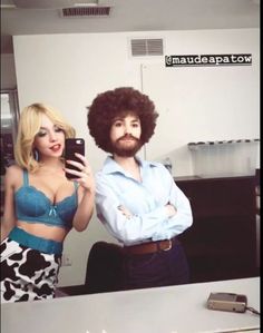 a man and woman are standing in front of a mirror with an afro haircut