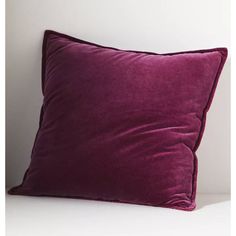 a purple pillow sitting on top of a white table