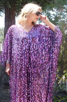 Check out our Black/Purple Sequin Caftan Dress! Featuring large iridescent round sequins and black sheer, lightweight fabric. The oversized kimono-style sleeves add a touch of drama, while the one size fits all design ensures a comfortable and flattering fit for everyone. Don't miss out on this must-have addition to your wardrobe!MeasurementsWidth: 46" Length: 50-56" For care instructions, we recommend hand washing with cold water. The item will typically be created within 2-3 business days prio Long Sleeve Purple Party Kaftan, Summer Festive Sequined Kaftan, Bohemian Sequin Kaftan For Parties, Summer Party Kaftan With Sequins, Spring Party Kaftan With Sequins, Summer Party Sequin Kaftan, Summer Party Sequined Kaftan, Bohemian Festival Kaftan With Sequins, Bohemian Sequin Kaftan For Festivals