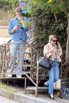 a man and woman walking down the street