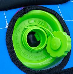 a green water bottle sitting on top of a blue mat