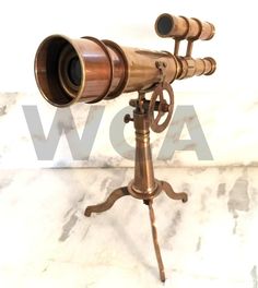 an antique brass telescope on a tripod stand