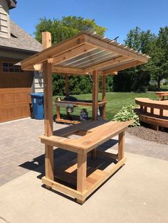 a wooden picnic table sitting on top of a patio