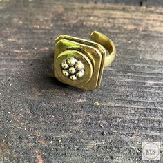 This Bold And Chunky Brass Flower Ring Features Rounded Square Edges Framing A Patterned Flower Center. Brass Adjustable Sizing. Ring Design Measures 1.25-Inches In Height By .75-Inch In Diameter. Fair Trade Made In India: Re-Imagining The Aesthetics Of Sustainable, Ethical Fashion, This Ring Is Handmade By Artisans In Village Communities In India, Often Times Using Eco-Friendly Materials. We Are Pleased To Work With Asha Through Our Partnership With Global Crafts. Our Ring Will Come In A Linen Adjustable Gold Brass Flower Ring, Adjustable Gold Flower Ring In Brass, Adjustable Brass Flower Ring, Adjustable Brass Flower Ring As Gift, Adjustable Flower Shaped Metal Ring, Adjustable Metal Flower Ring, Adjustable Vintage Gold Flower Ring, Vintage Adjustable Gold Flower Ring, Adjustable Metal Flower Ring With Open Design