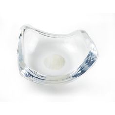 a clear glass bowl sitting on top of a white table