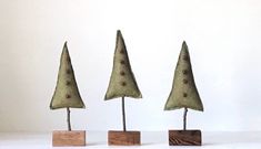 three small wooden trees sitting on top of each other