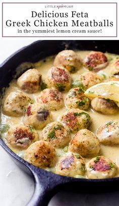 a pan filled with meatballs covered in gravy next to a lemon wedge