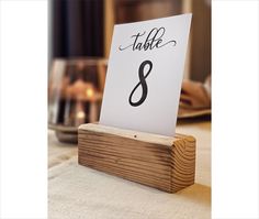 a wooden table with a sign that says table 8