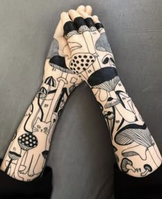 a pair of gloves with designs on them