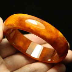 59mm Golden Yellow and White Clouds Hand-carved Natural Jade Bangle #A3 weight: 76.5g, 421.5 Ct Jade NameNatural Jade Item SizeInner diameter: 58 mm Width:17.6mm Thickness: 7.1 mm This unique bangle has lots of internal feature with clouds, silk streaks and wen. Inviting autumn color with this golden orange tawny with white flowers. This is a gorgeous and high quality jadeite bangle. Luxury Collectible Round Bangle, Luxury Carved Bracelet Jewelry, Carved Brown Bangle Jewelry, Brown Carved Bangle Jewelry, Brown Carved Bracelet Jewelry, Luxury Carved Bangle Jewelry, Carved Round Bracelets For Wedding, Carved Round Wedding Bracelets, Formal Brown Round Bangle