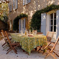 the table is set outside in front of an old building