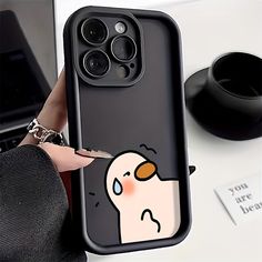 a person holding an iphone case with a cartoon character on it