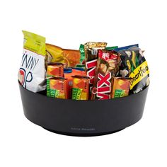 a black bowl filled with lots of different types of snacks and candy bar wrappers