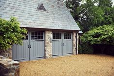 a stone building with two garage doors on each side