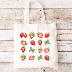 "Personalized Strawberry Tote Bag Strawberry Lover Gift Cute Grocery Tote Cute Farmers Market Bag Gift for Her Eco Friendly Reusable Grocery Bag Produce strawberry, strawberry gift, summer tote bag, summer bag, spring tote bag, spring bag, strawberry bag, strawberry lover, farmers market bag, book bag, reusable bag, eco friendly tote, school tote, Everyday Bag, Shoulder Bag, Canvas Tote, Cute Tote Bag, School Bag, book tote bag, school tote bag, aesthetic tote bag, reusable grocery bag, library bag, aesthetic tote, campus bag, campus tote bag Strawberry Bliss Eco-Friendly Tote Bag - the perfect companion for your sustainable shopping journey! Say goodbye to single-use plastic bags and embrace eco-conscious living with this charming and practical tote. Make a positive impact on the planet b Cute Farmers Market, Strawberry Tote Bag, Spring Tote Bag, Strawberry Bag, Spring Tote, Strawberry Gifts, Tote Bags For School, School Tote, Library Bag