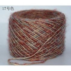 red and brown yarn is spooled on a white surface