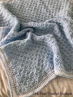 a crocheted blanket on top of a bed