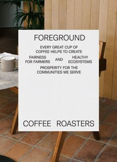 there is a sign that says coffee roasters on the side of the road and it's in front of a table