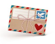 an envelope tied with twine and decorated with heart, mail stamp and love note