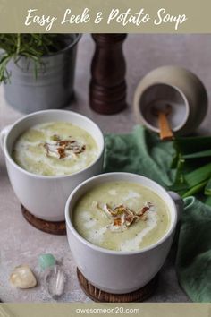 two white bowls filled with soup on top of a table