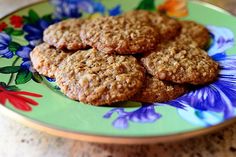 some cookies are on a colorful plate with flowers