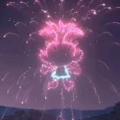 fireworks are lit up in the night sky with pink and blue colors on it's side