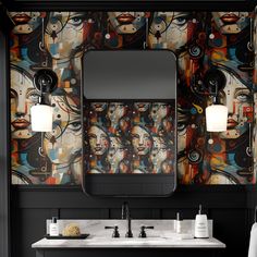 a bathroom with black walls and colorful artwork on the wall, along with two sinks