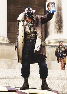 a man dressed in costume standing on top of a skateboard